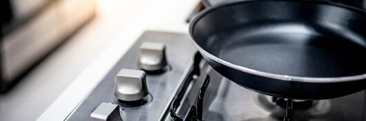 Teflon pan on stove in kitchen.