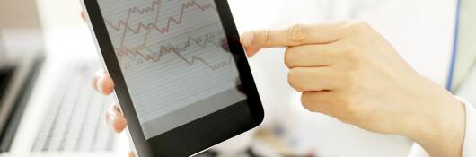 Doctor hands hold and show digital tablet pc to patient.