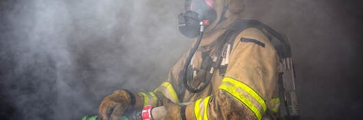 Firefighter ready to spray water