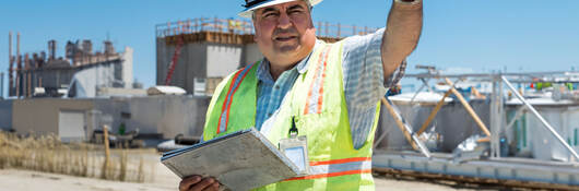 A construction worker pointing