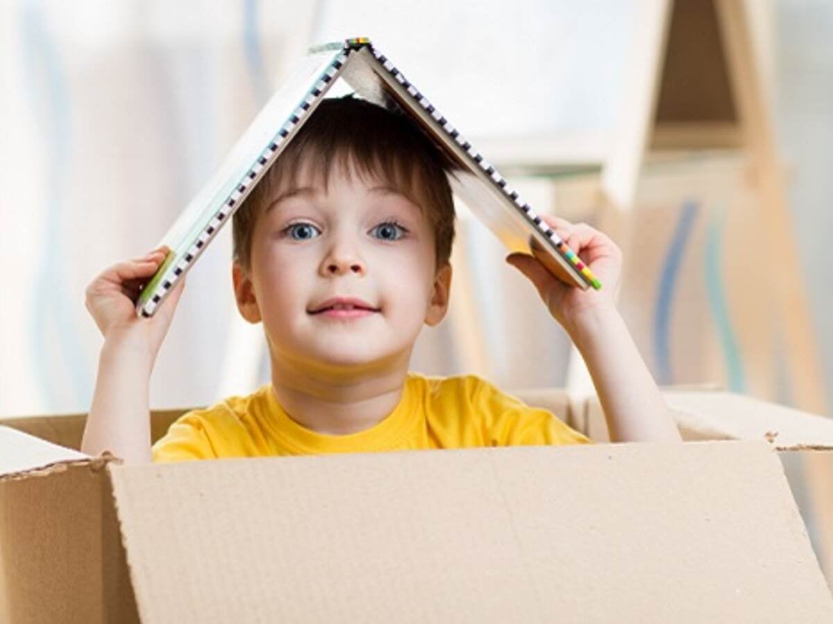 kid boy playing in a toy house