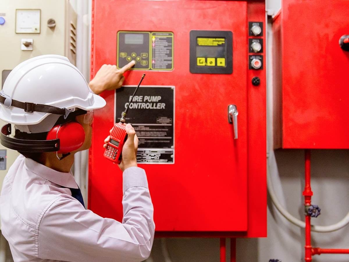 An inspector looks at a fire pump