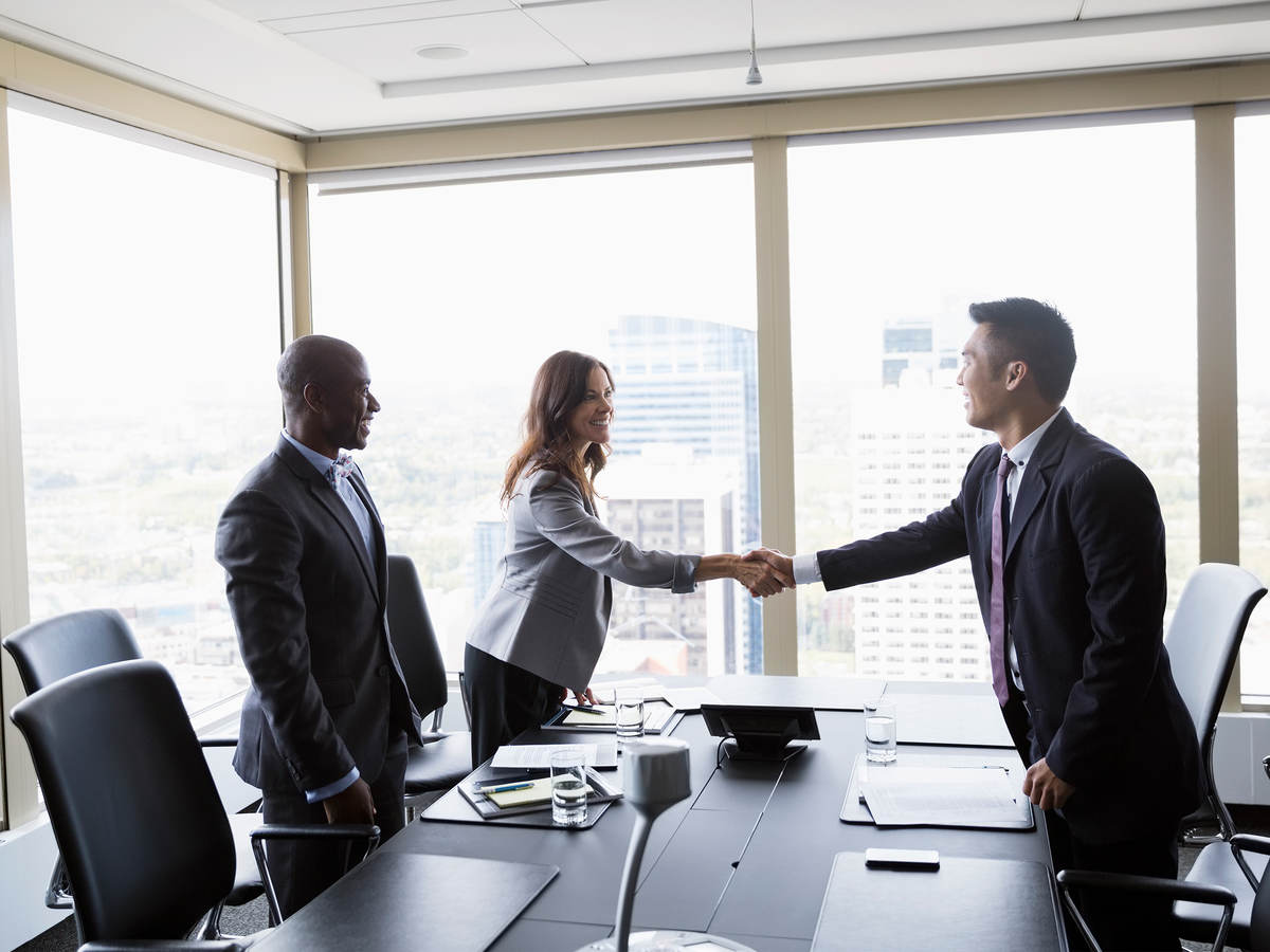 Workers shaking hands in a meeting