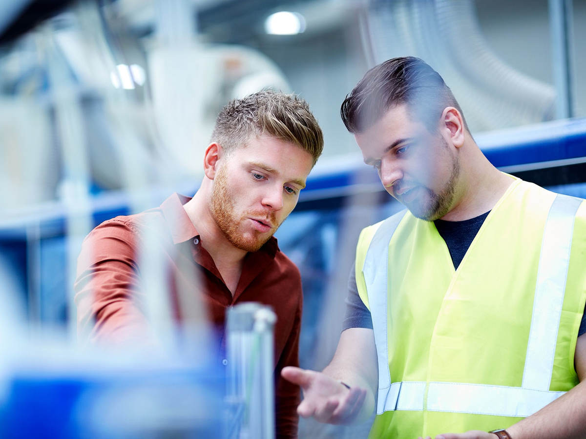 two young men conducting cable inspection for compliance