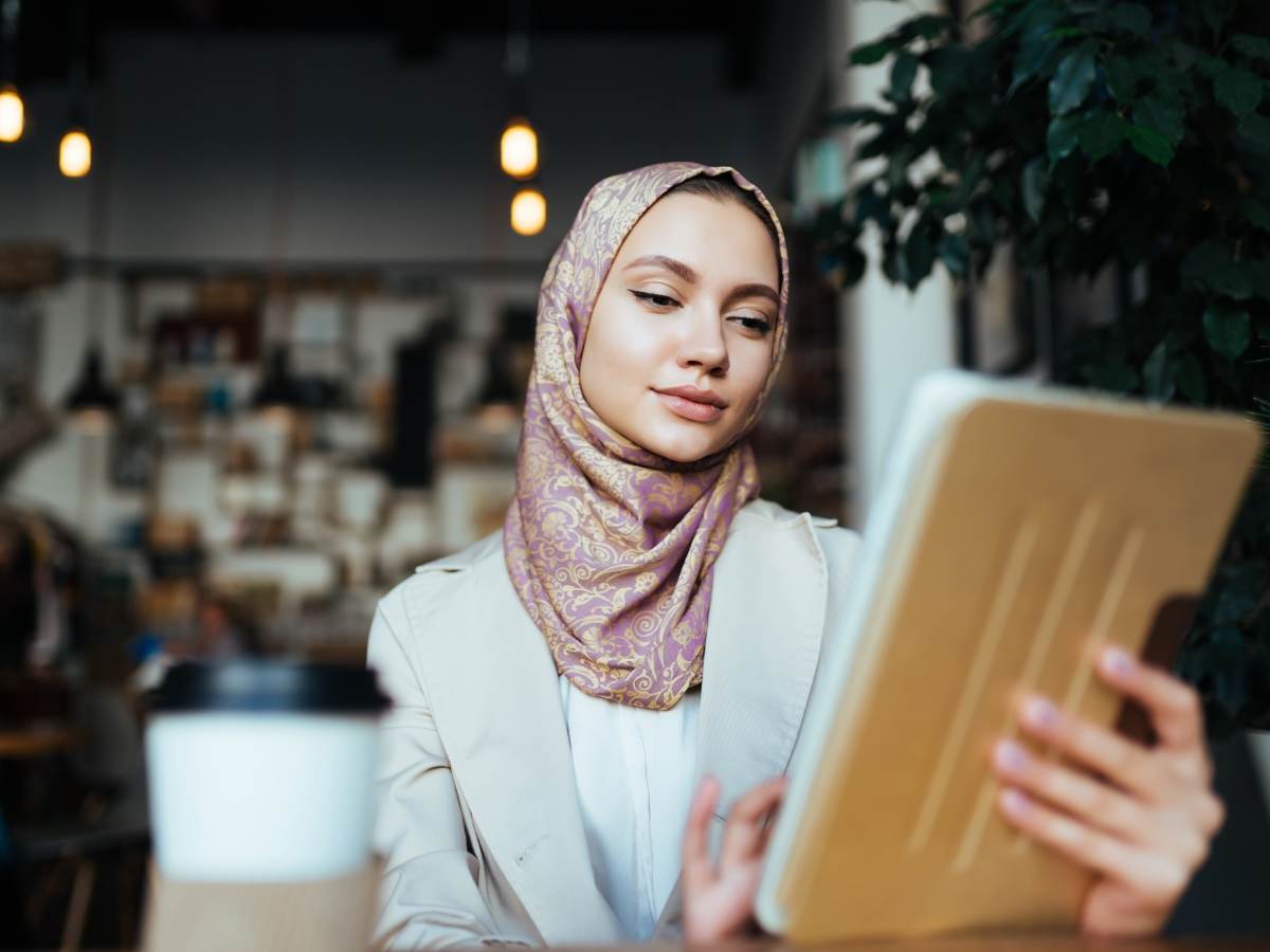 A Saudi Arabian girl with tablet computer in a city