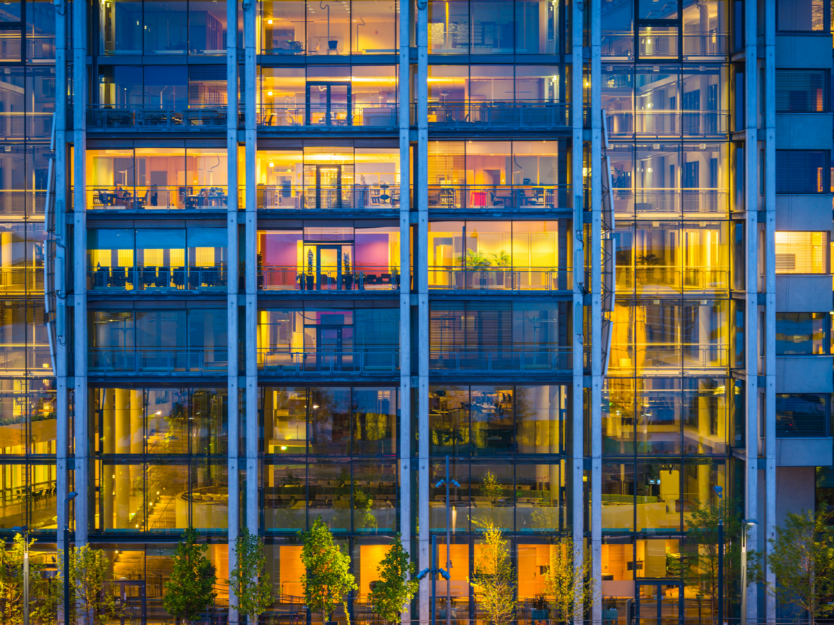 Business office building windows illuminated at dusk