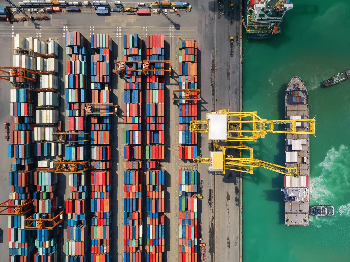 Overhead view of shipping containers being moved from a ship