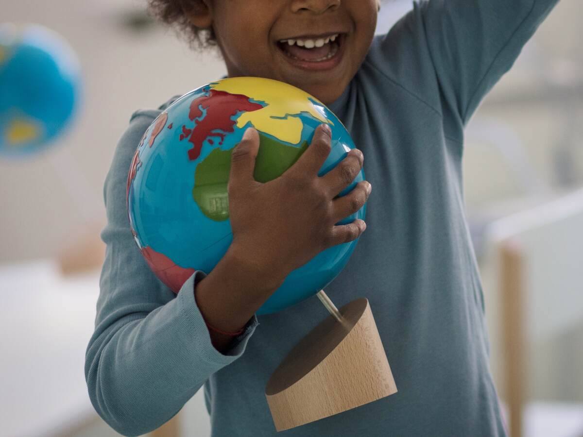 Child holding a toy ball.