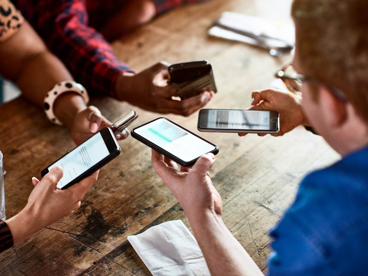 Friends sharing information on smartphones