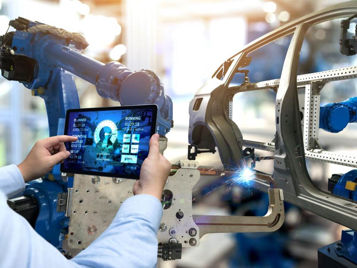 Main holding tablet in front of automated assembly line