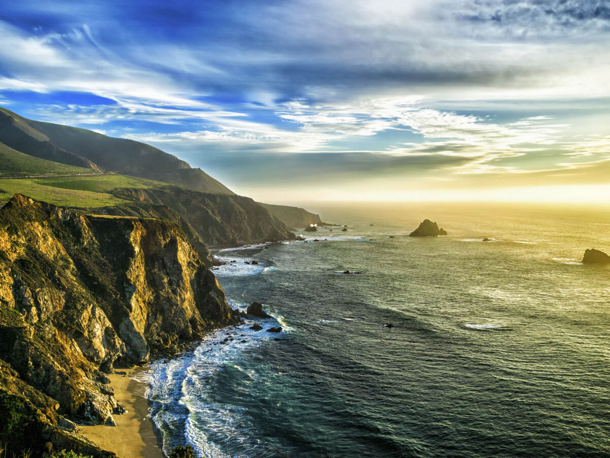 The coastline at Big Sur, California, with steep cliffs and rock stacks in the Pacific Ocean