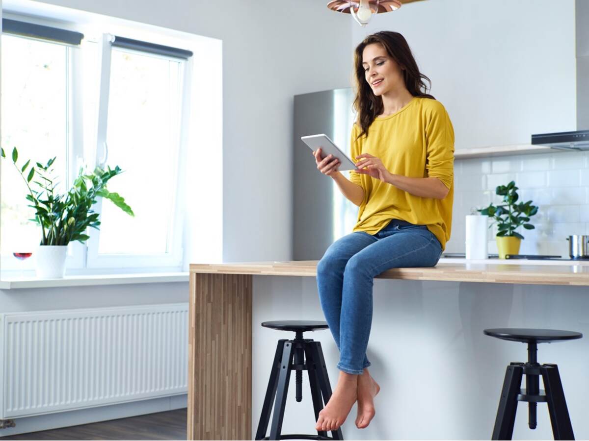 Women sitting on counter with tablet