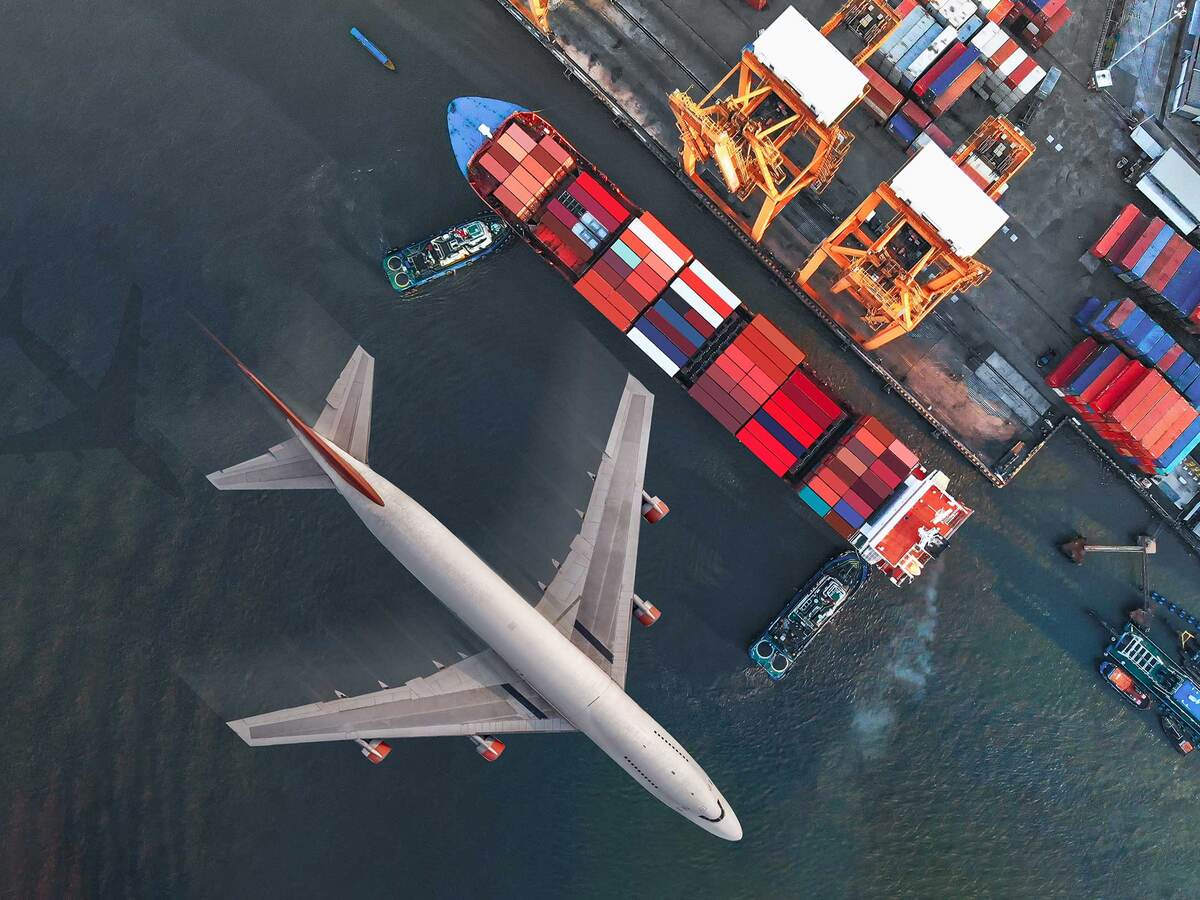 Plane flying over a shipyard