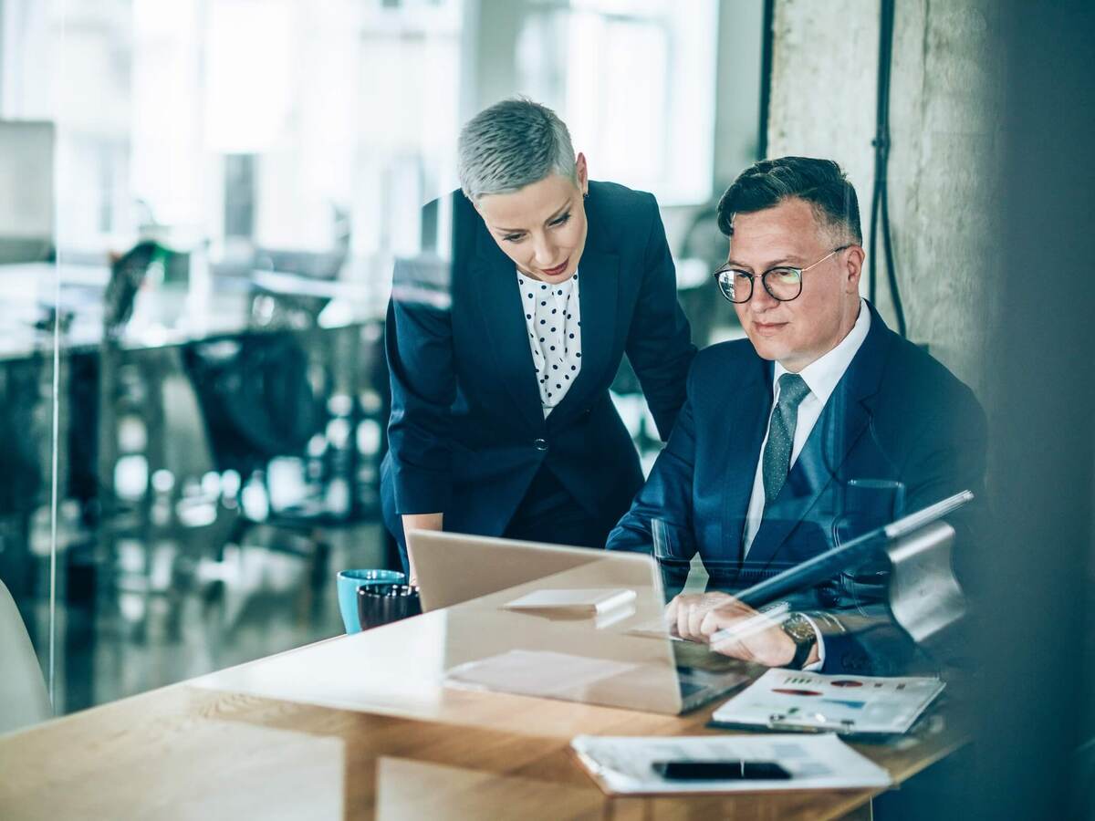 Two business colleagues collaborating over a laptop