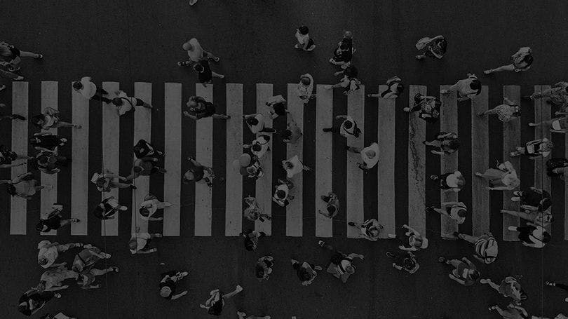 People walking across a pedestrian crossing