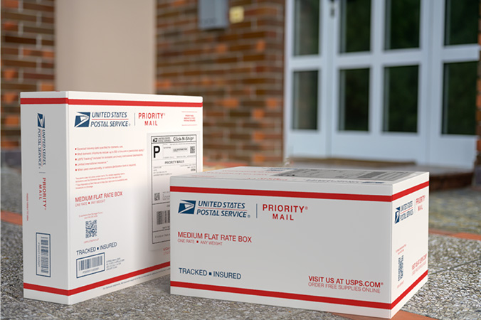 Priority Mail boxes on a house porch awaiting pickup.