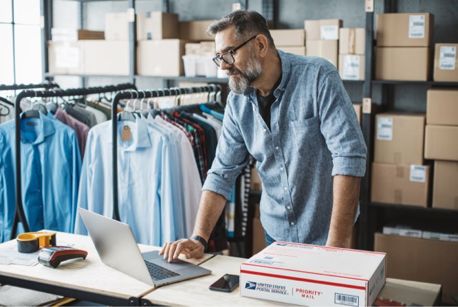 Small Business owner preparing to ship Priority Mail packages.