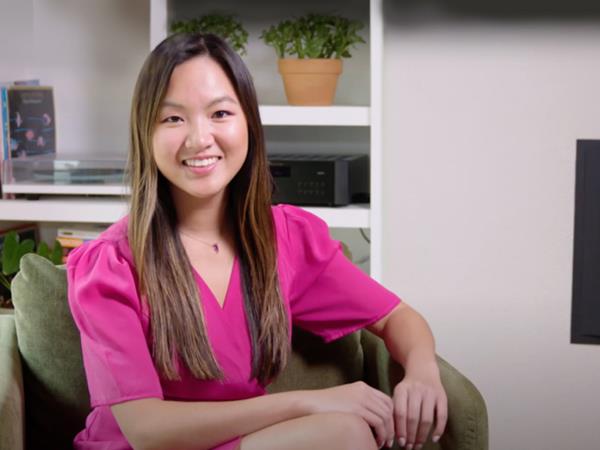 Woman In Pink Shirt Sitting In Green Chair Talking