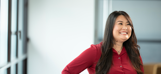 Woman Wearing Red Shirt Smiling At Co Worker