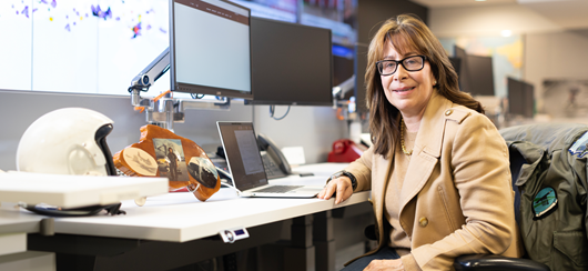 Middle Aged Woman Sitting At Her Desk Trouble Shooting