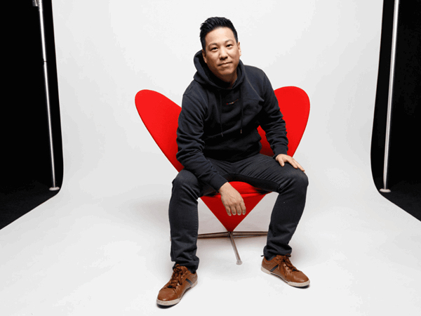 Man With Black Hoodie Sitting On Red Chair Looking Cool