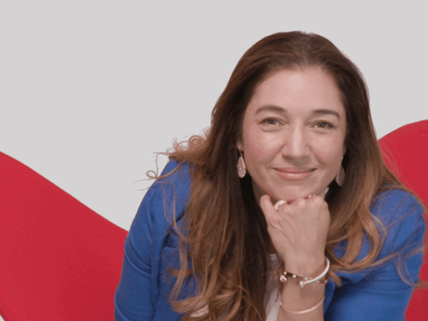 Woman Sitting On A Red Chair Smiling