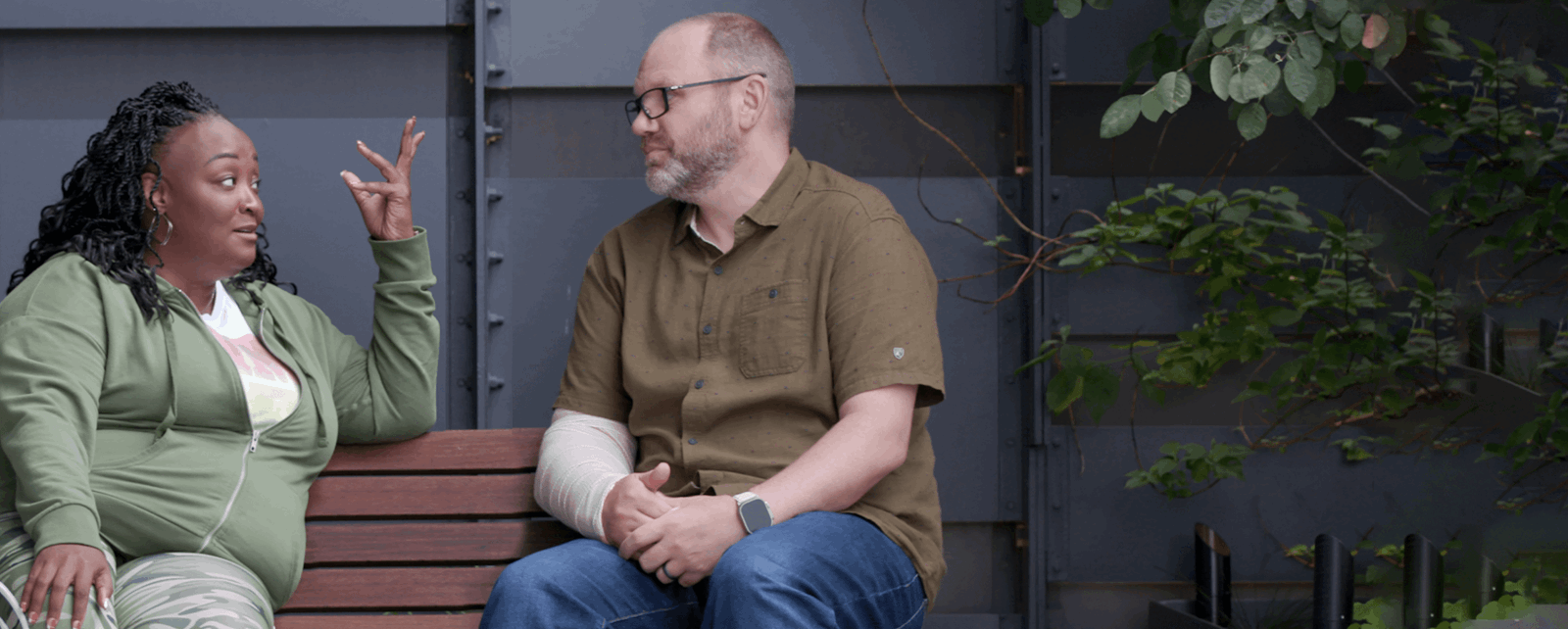 Two Employees Sitting On A Bench Deep In Conversation