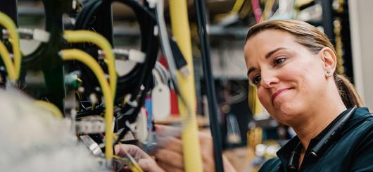 Verizon Woman Technician Busy Working In A Server Room Smiling