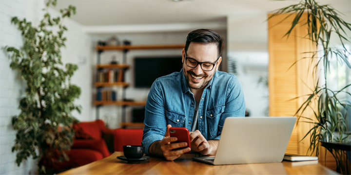 man on phone with laptop