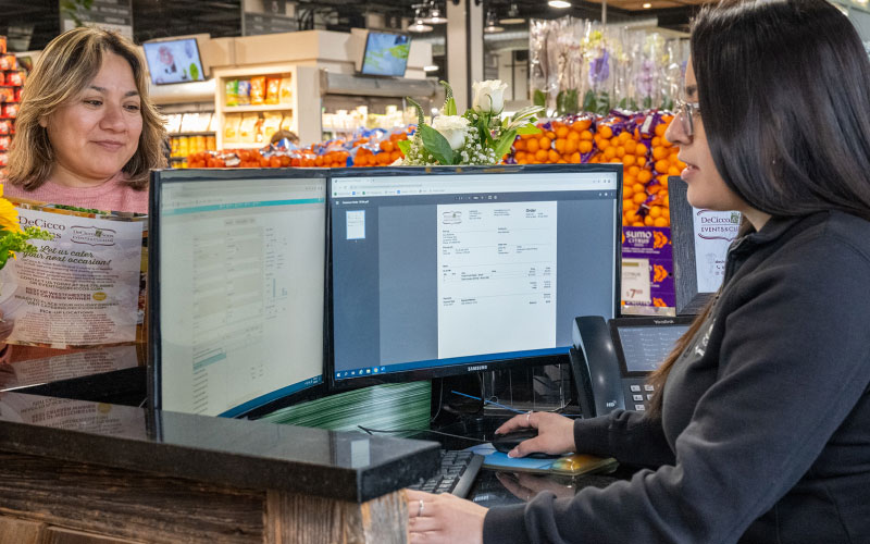 shop assistant and a customer in a grocery store