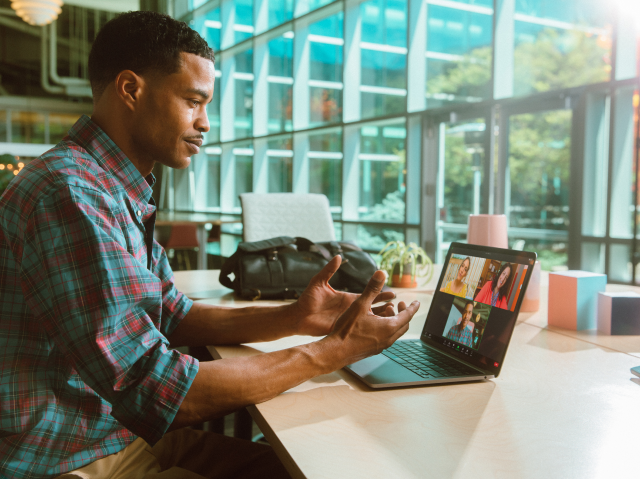 Man at desk using Zoom meetings