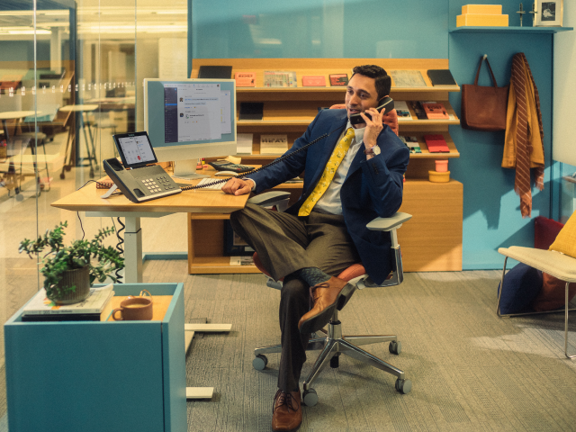 Office worker using corded phone