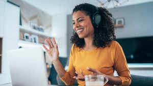 Mujer saludando en una reunión virtual