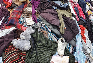 large pile stack of textile fabric clothes and shoes. concept of recycling, up cycling, aw