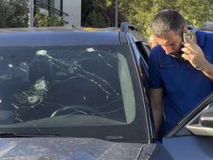 A police officer inspects a car in which a hand-held pager exploded, in Beirut, Lebanon, Tuesday, Sept. 17, 2024.