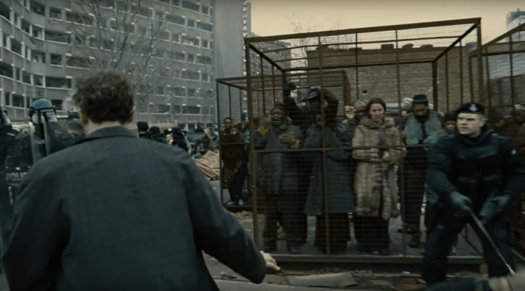 A screenshot of the refugee cages from the theme setting first minutes of the film.