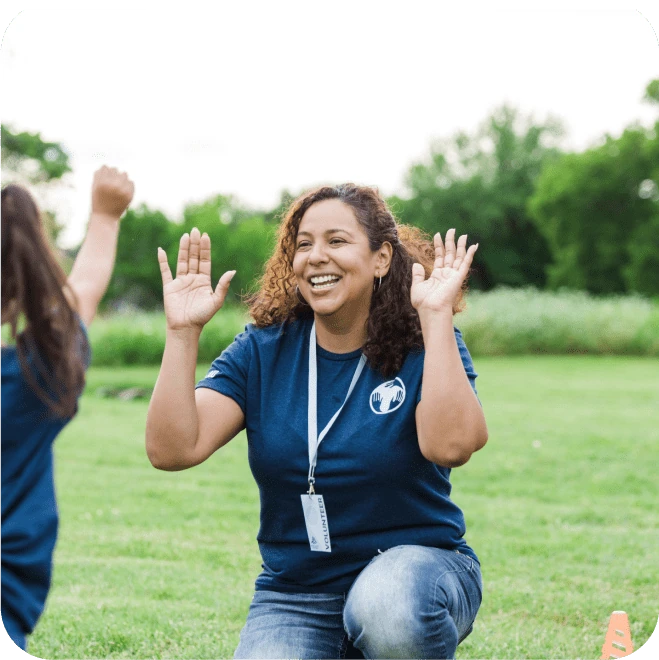 A charity worker enjoying participating in an activity with a child