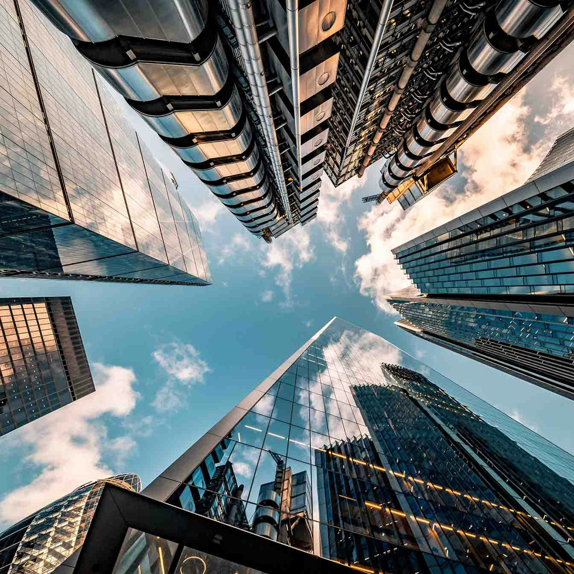 looking up toward the sky surrounded by skyrises 