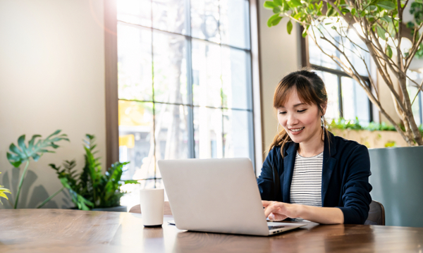 Portrait smile beautiful business asian woman in pink suit working in office desk virtual computer. Small business owner people employee freelance online sme marketing e-commerce telemarketing concept