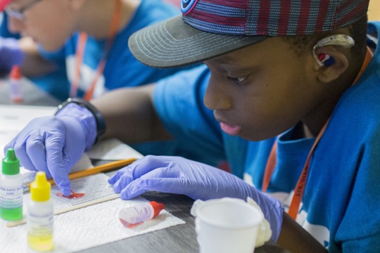 Young male student conducting science experiment