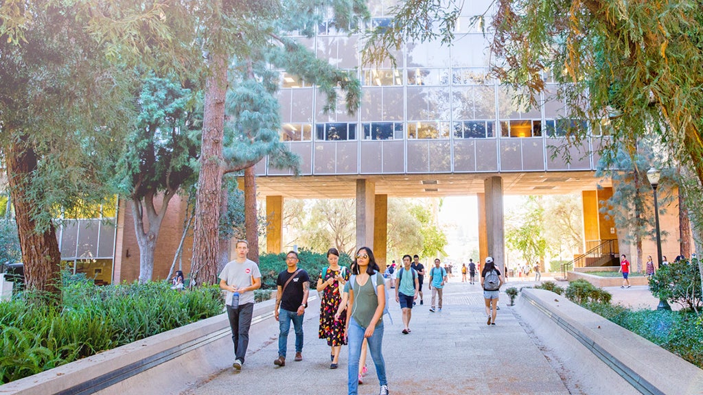 Students head to and from north campus by passing under Bunche Hall.