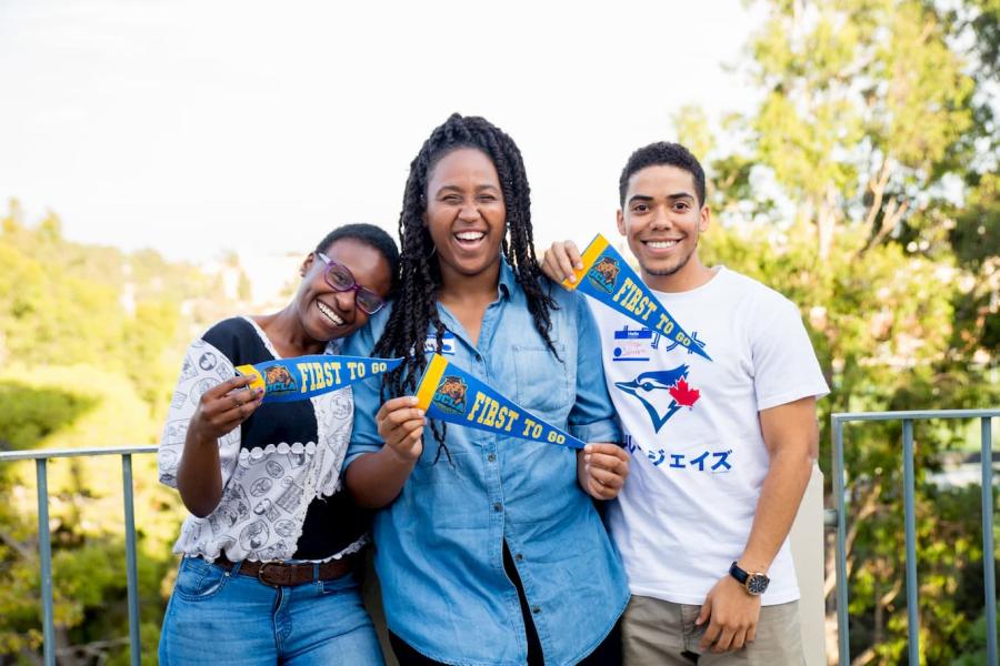 First to go students holding UCLA flags