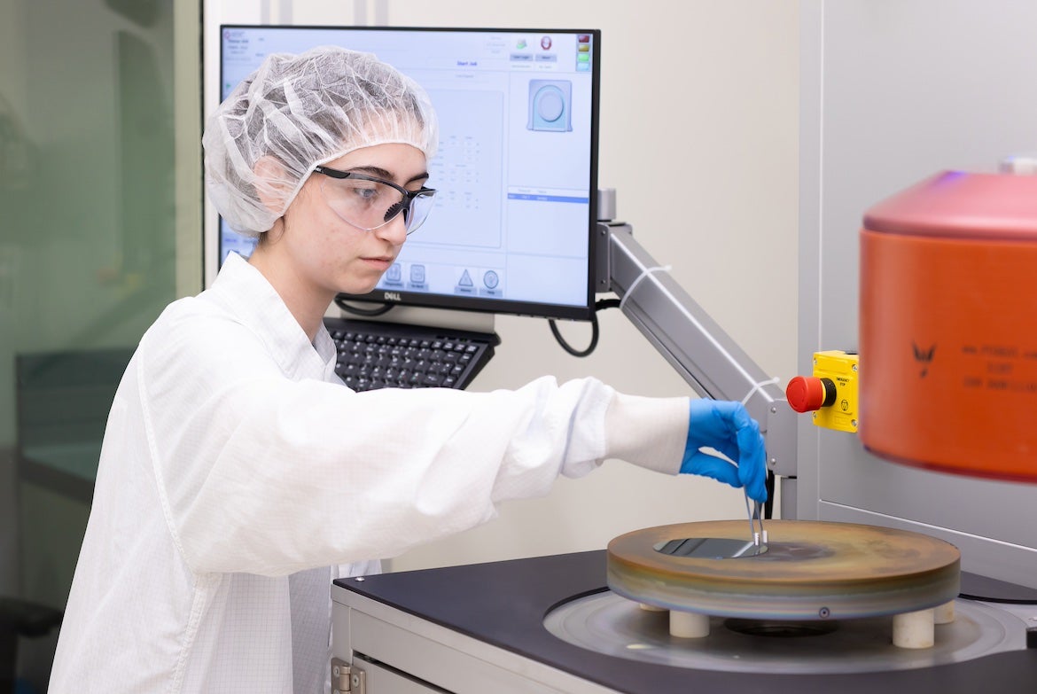 Woman in white lab coat working with laboratory instruments