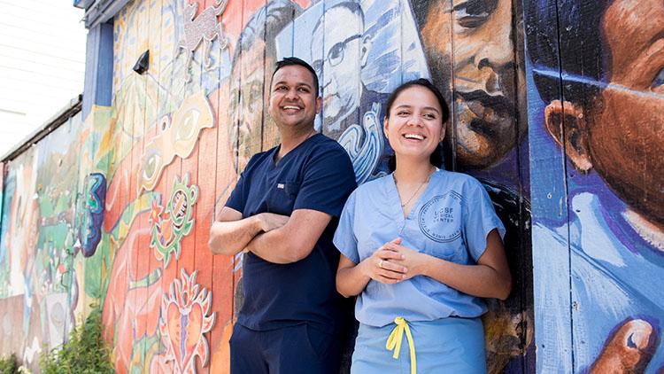 UCSF dental students Elliott Pereira (L) and Heydi Dutan do community work in the Mission district of San Francisco.