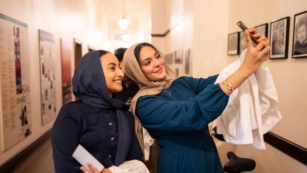 two students take selfie in hallway