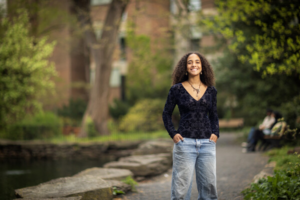 Mya Gordon stands on the walkway near the Bio Pond with hands in her pockets