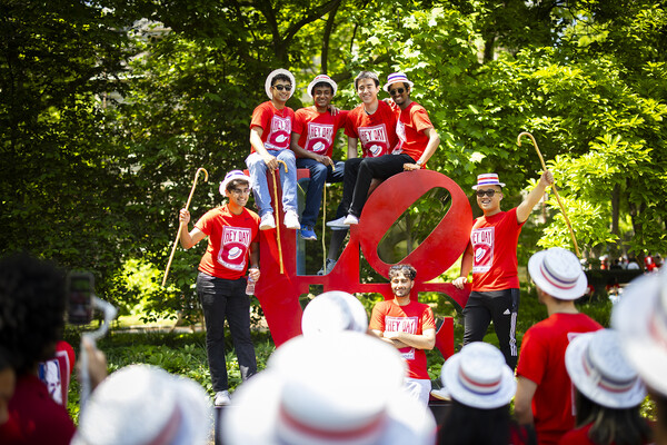 students climb the love statue during hey day