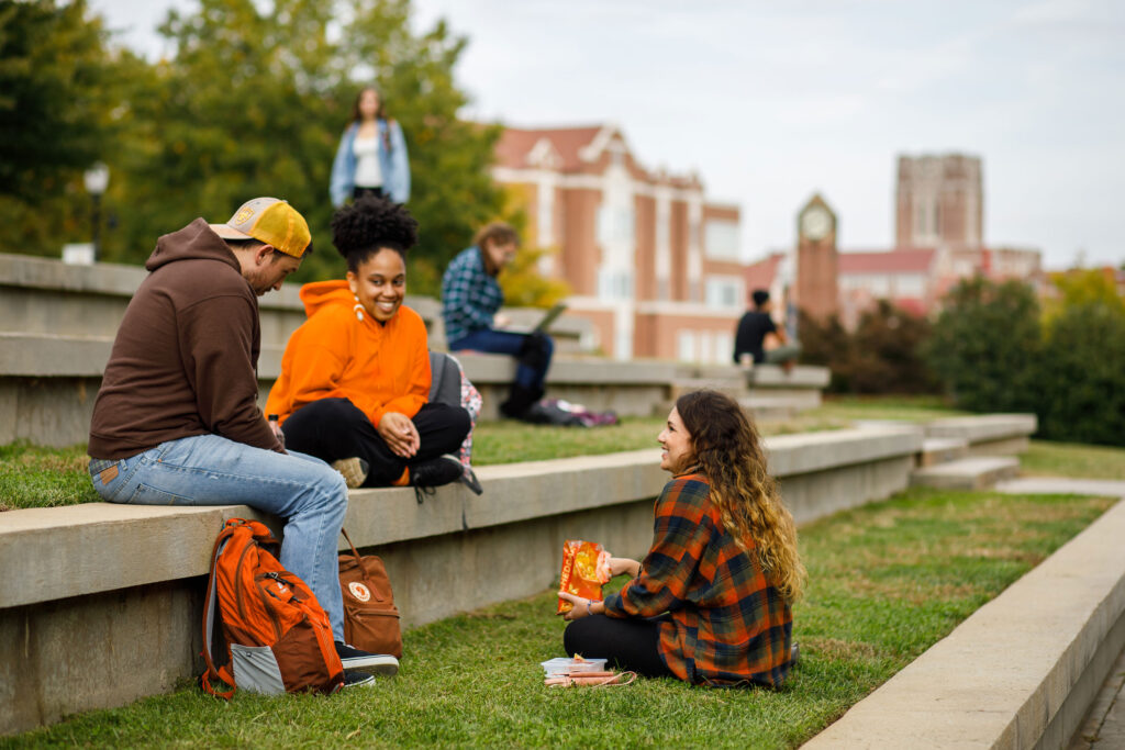 Students sit in the amphitheater hanging out between class