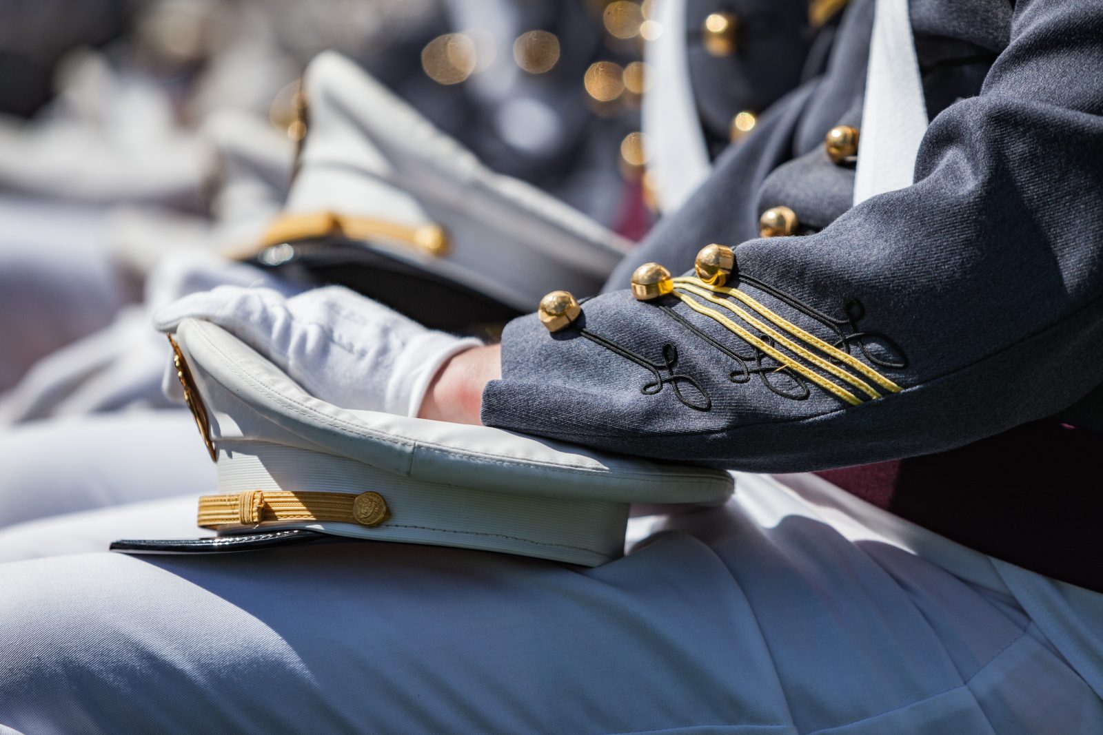 U.S. Military Academy cadets sitting with hats