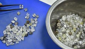 An employee inspects rough diamonds in Alrosa Diamond Sorting Center in the town of Mirny on July 1, 2019.ALEXANDER NEMENOV/AFP via Getty Images